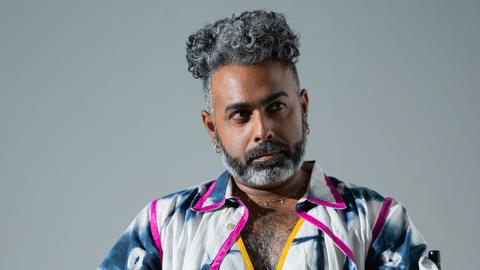 man sitting in a chair looking off camera