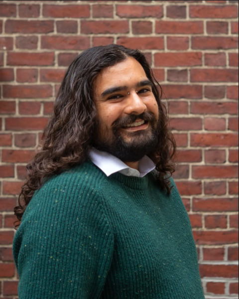 person with long brown hair and sweater